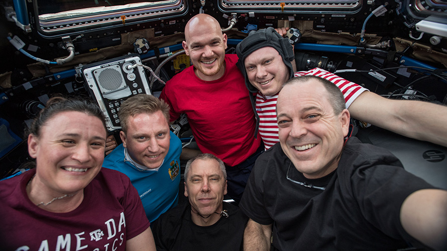 Astronaut Serena Auñón-Chancellor wearing Aggie Game Day Physics T-shirt on board the International Space Station.